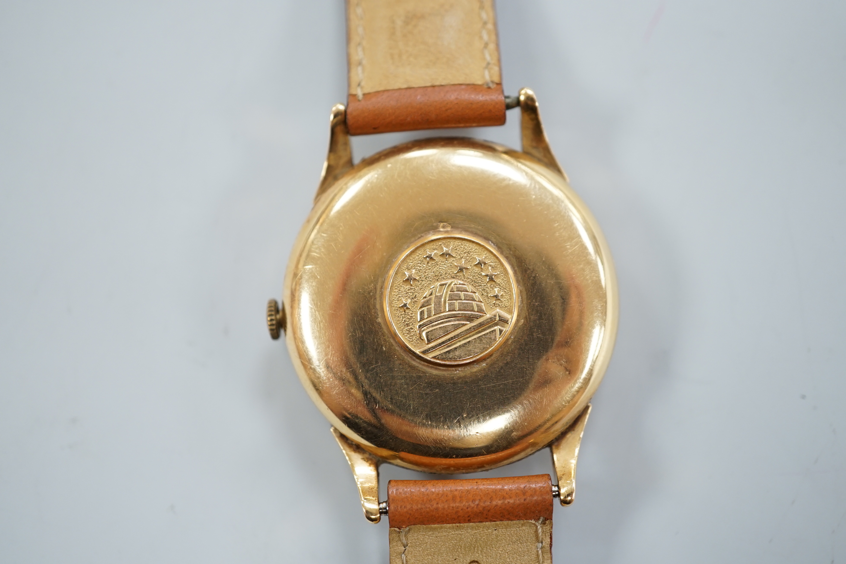A gentleman's 1950's yellow metal (French 18ct poincon mark) Omega Constellation automatic wrist watch, on associated strap, case diameter 35mm, dial a.f.